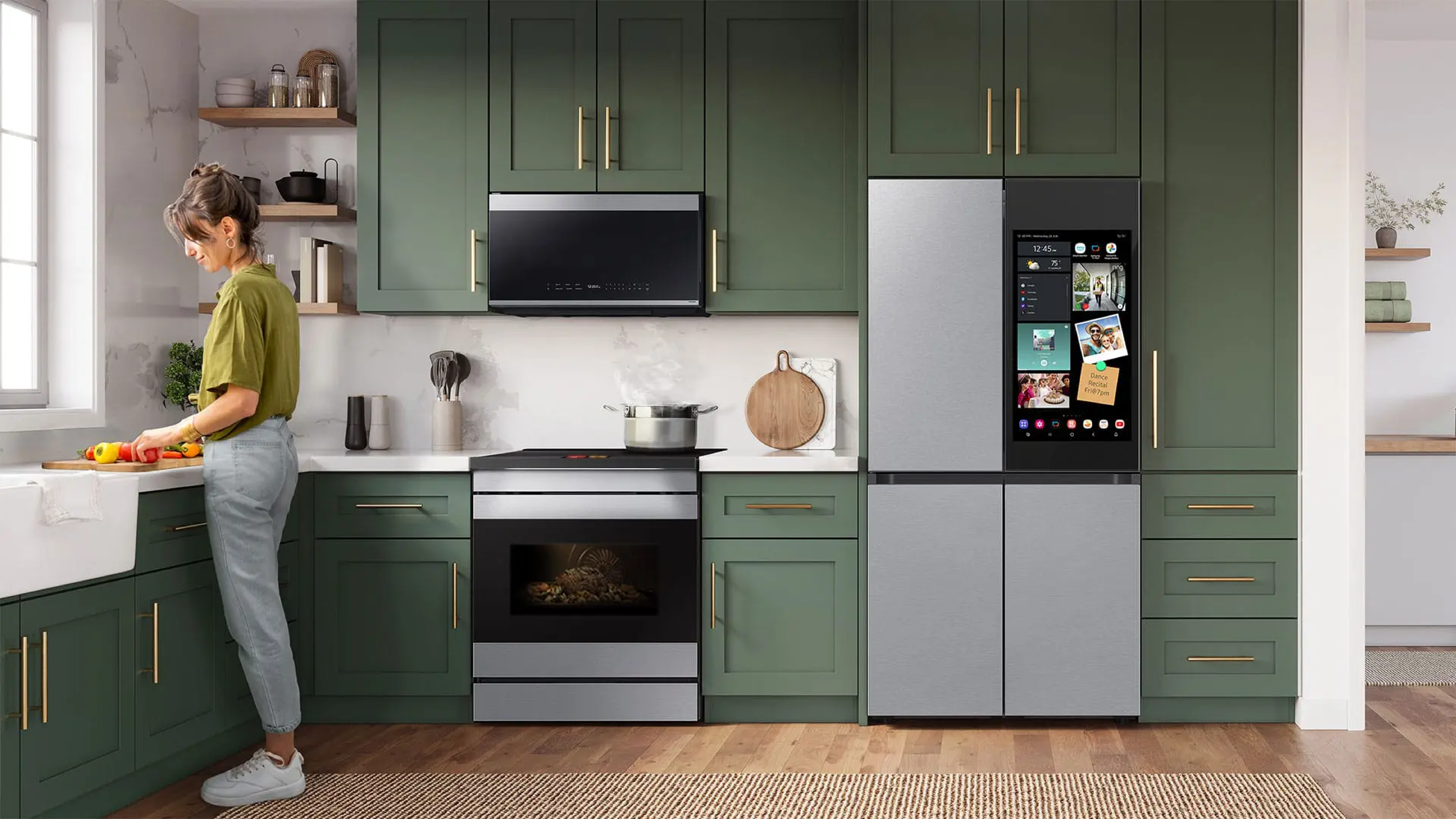 Kitchen with stainless steel Samsung appliances and green cabinetry